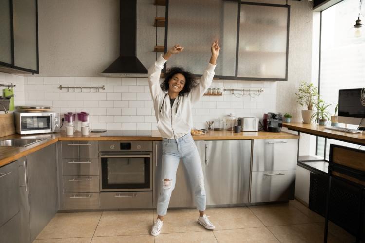 Woman dancing alone in a kitchen