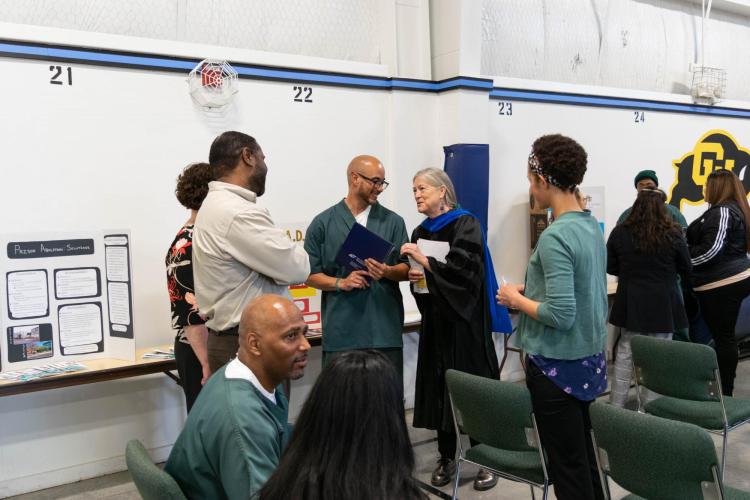 Photograph of Belknap talking with students and their families