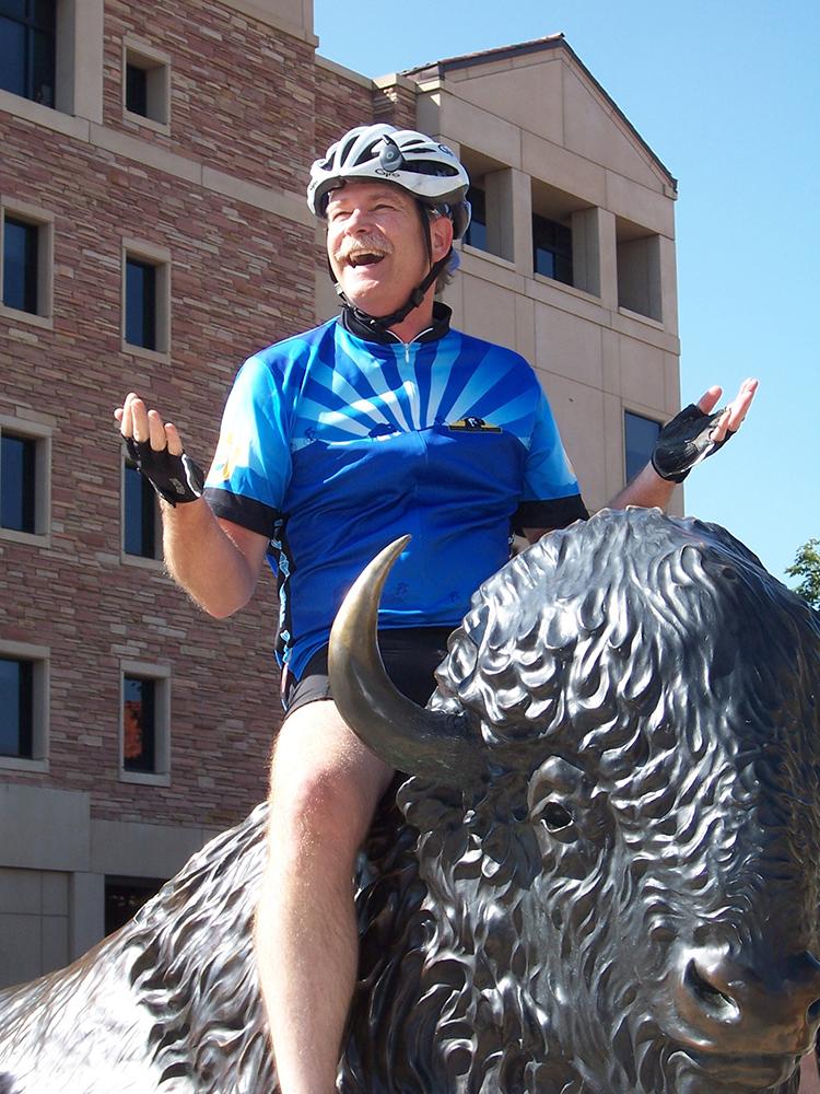 Todd Gleeson rides a buffalo sculpture at CU Boulder