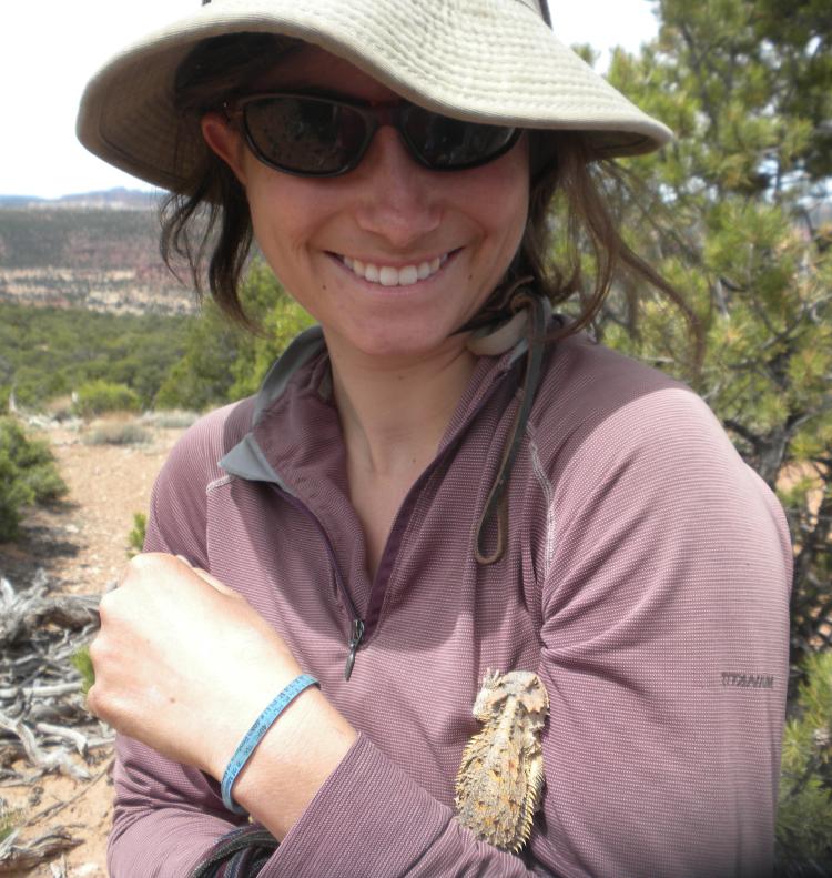 Miranda Redmond pauses for a moment with a horned lizard on her arm in 2011 as she works on Wray Mesa, Utah, near the La Sal Mountains.