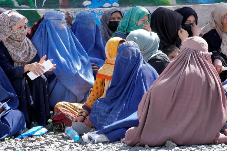 Women in Afghanistan seated on the ground