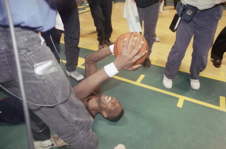 Dikembe Mutombo celebrating with rebound ball