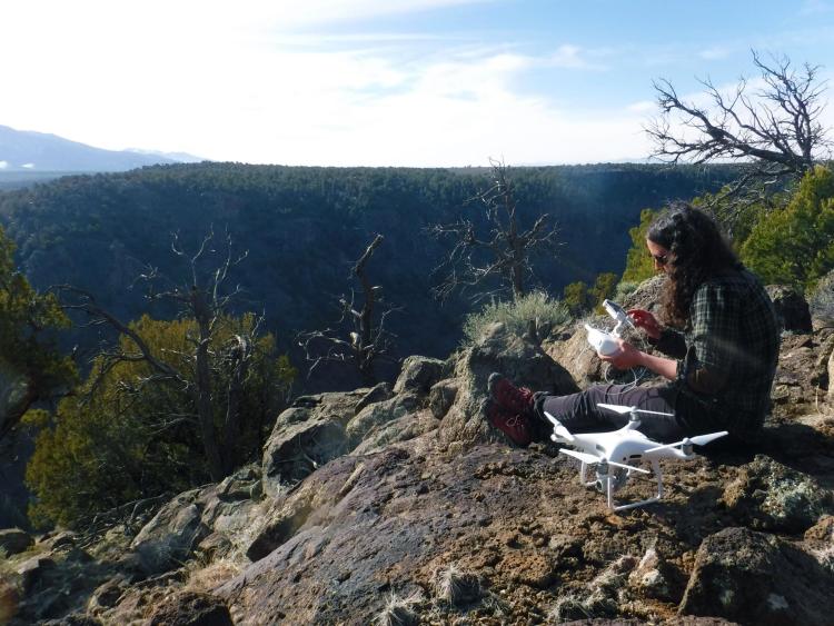 researcher sitting on top of rocks