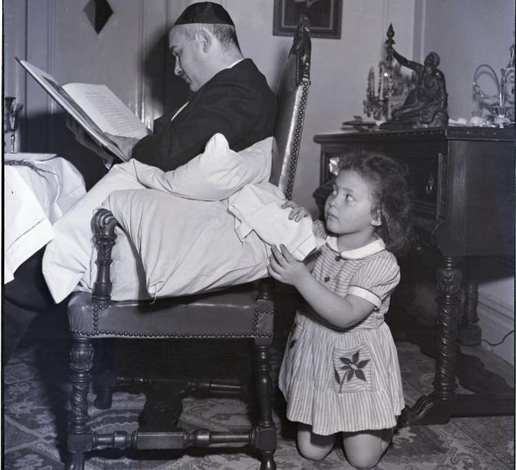 A young girl pretends to ‘steal’ the Afikomen, as part of the celebrations. Bettmann via Getty images