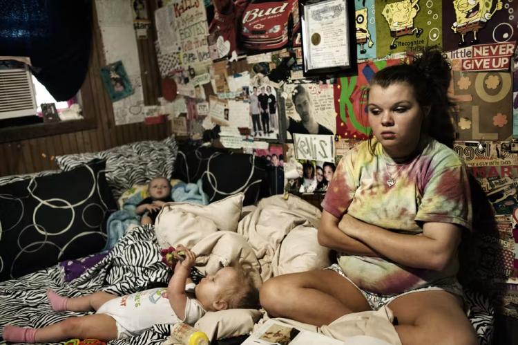 Maranda Corely, 19, sits in her bedroom with her three children in Ellisville, Mississipi.