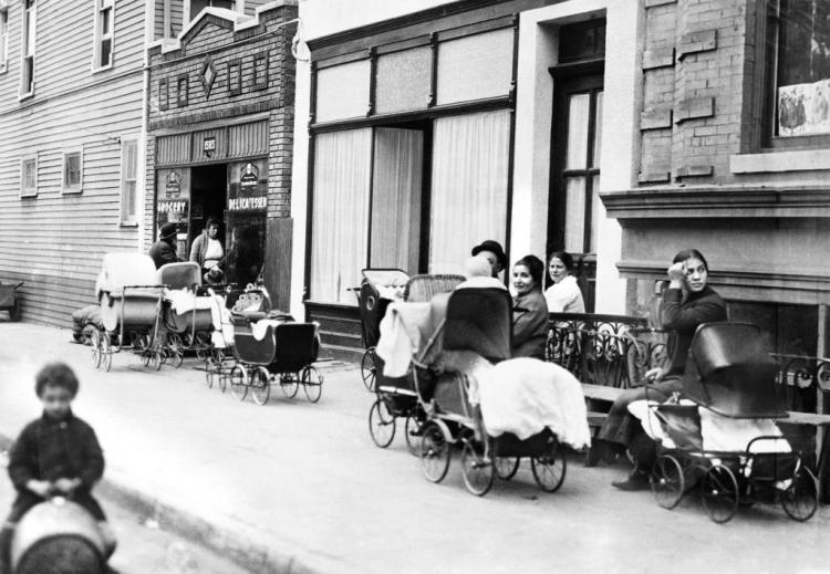 Women with children stand outside Sanger Clinic, the first birth control clinic in United States, in Brooklyn, New York in 1916.