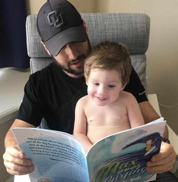 Travis and Son reading Max Goes Surfing