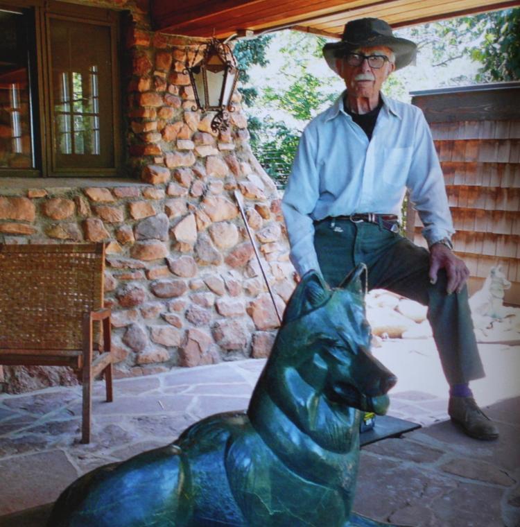 Lynn Wolfe with his Wolf Sculpture