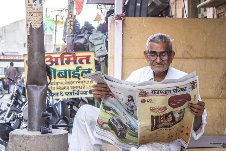 Man in Rajasthan, India, reading a Hindi newspaper