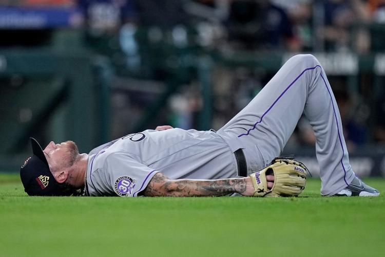 Colorado Rockies pitcher Kyle Freeland lying on field