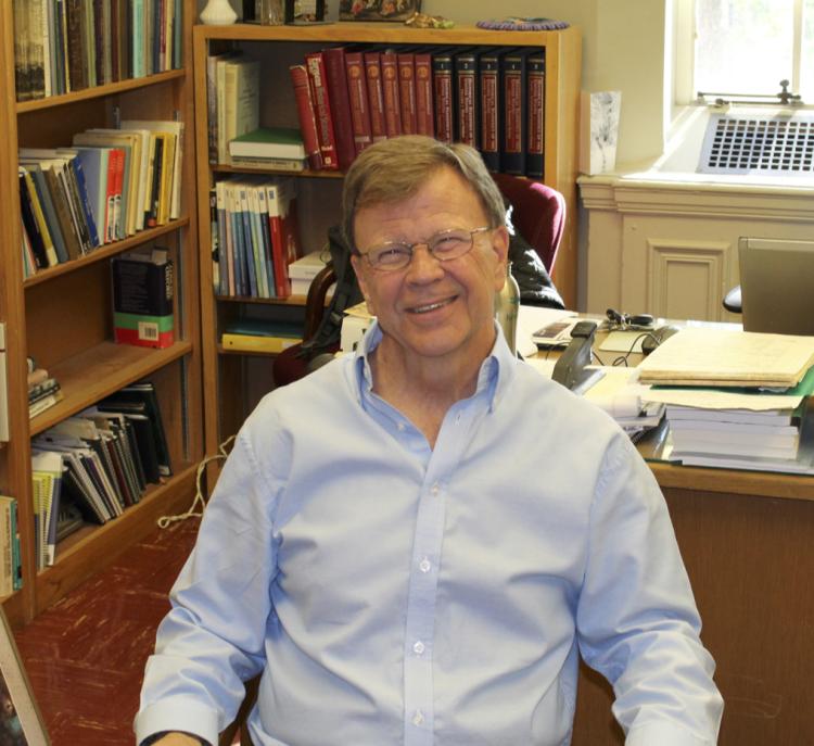 Markusen sitting in his office