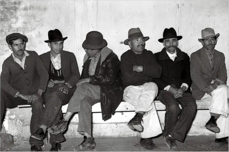 men sitting on a bench