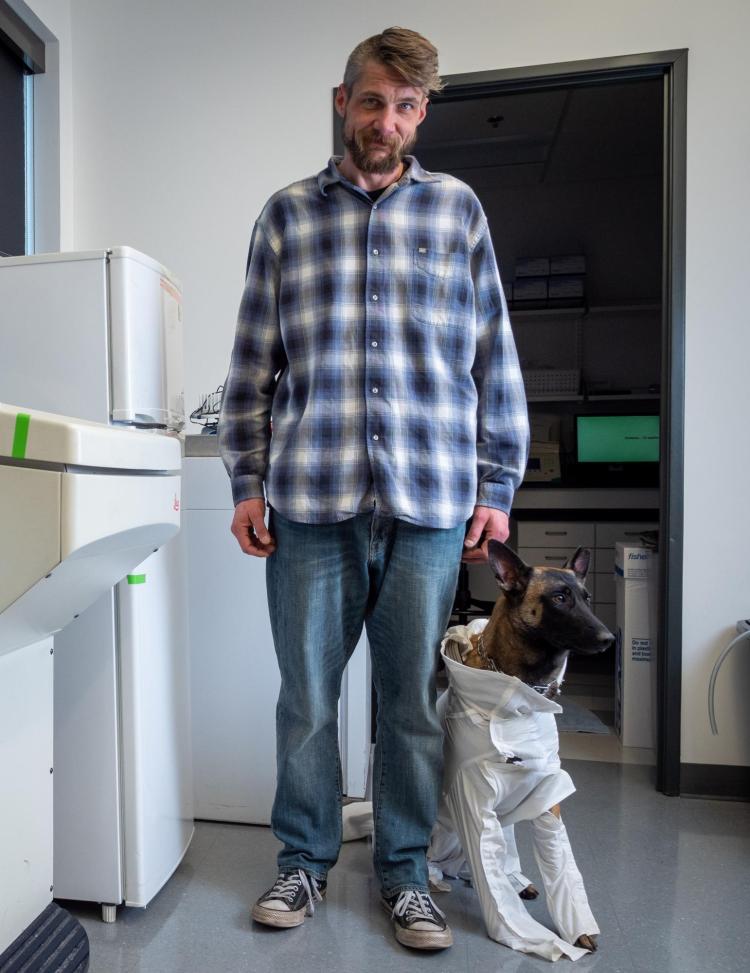 Xenna, a service dog, standing next to her owner for Jon Coulson
