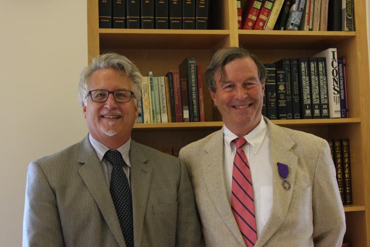 Warren F. Motte, Jr. (right) receives his medal from Jeffrey Richards, Honorary Consul of France (left) at a ceremony on Sept. 17, 2015. Photo by Laura Kriho.