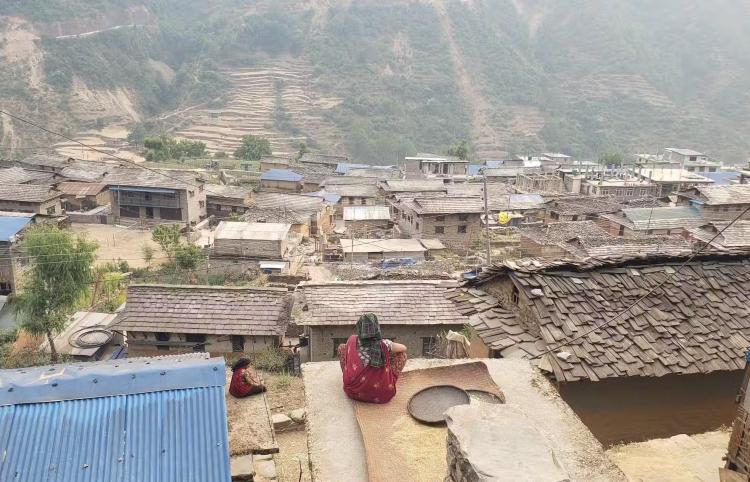 Woman sitting on roof in Nepal