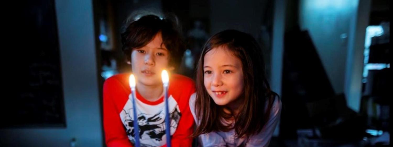Boy and girl looking at candles