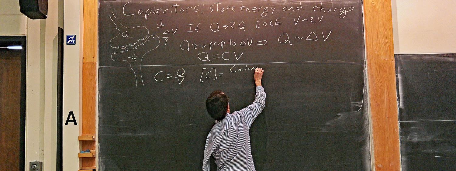 Eric Cornell writing on blackboard