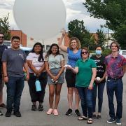 2022 cohort of the REU students in front of a weather balloon