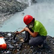 Sarah Black, who recently completed her PhD in Geological Sciences at CU Boulder, collects water samples from Laguna Caliente.