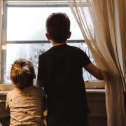 Kids looking out a window