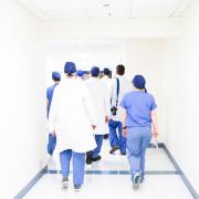 doctors walking down a hallway in a hospital