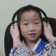 Child getting headphones put on their head