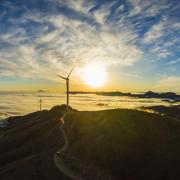 Stock photograph of a wind turbine at sunset