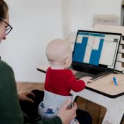 Woman working with a child on her lap