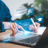 hand pointing at laptop keyboard with AI images floating above it
