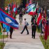 Students on college sidewalk lined by international flags