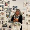 Melanie Yazzie with her art prints on a gallery wall
