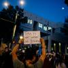 protesters in city street at night
