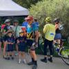 Cyclists standing at tent aid station in Buffalo Bicycle Classic