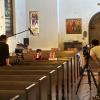 two children sitting on church pew being filmed for short film Cherry Yogurt