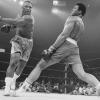 Muhammad Ali dodging a hit by Joe Frazier in boxing ring