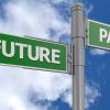 green signs with white writing saying "future" and "past" pointing in opposite directions