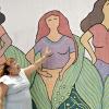 A woman presenting a mural as part of the UN's 16 Days of Activism Against Gender-Based Violence in 2017