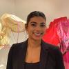 Shloka Dhar posing next to her thesis project made of metal and fabric.