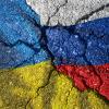 Ukraine's flag painted on a cracked surface