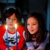 Boy and girl looking at candles