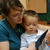 Child Learning Center Teacher Amy Thrasher, a speech language pathologist supervisor, is shown in 2006 working with 3-year-old Cameron Cass in the Speech, Language and Hearing Sciences department at CU. CU-Boulder Photo/Casey A. Cass.