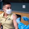 Osvaldo Villagrana, 24, an integrative physiology major at CU Boulder gets his first dose of the Moderna vaccine.