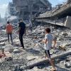 People walking through damage on Gaza Strip