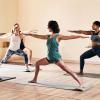 Women and men doing yoga in a studio