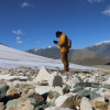 Archaeologist and paleoenvironmental researcher Isaac Hart of the University of Utah surveys a melting ice patch in western Mongolia. Peter Bittner, CC BY-ND