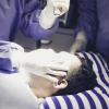A man getting his eyes checked for a concussion