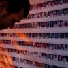 Man looking at photos of people disappeared in Nepal's civil war
