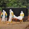 The body of a patient who passed away in Guinea is given back to the family for their funeral after being decontaminated by a team from Doctors Without Borders. Photo Amandine Colin/MSF