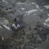 A house is shown surrounded by coal fly ash after a retention pond near Kingston Fossil Plant in Tennessee overflowed.