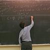 Eric Cornell writing on blackboard